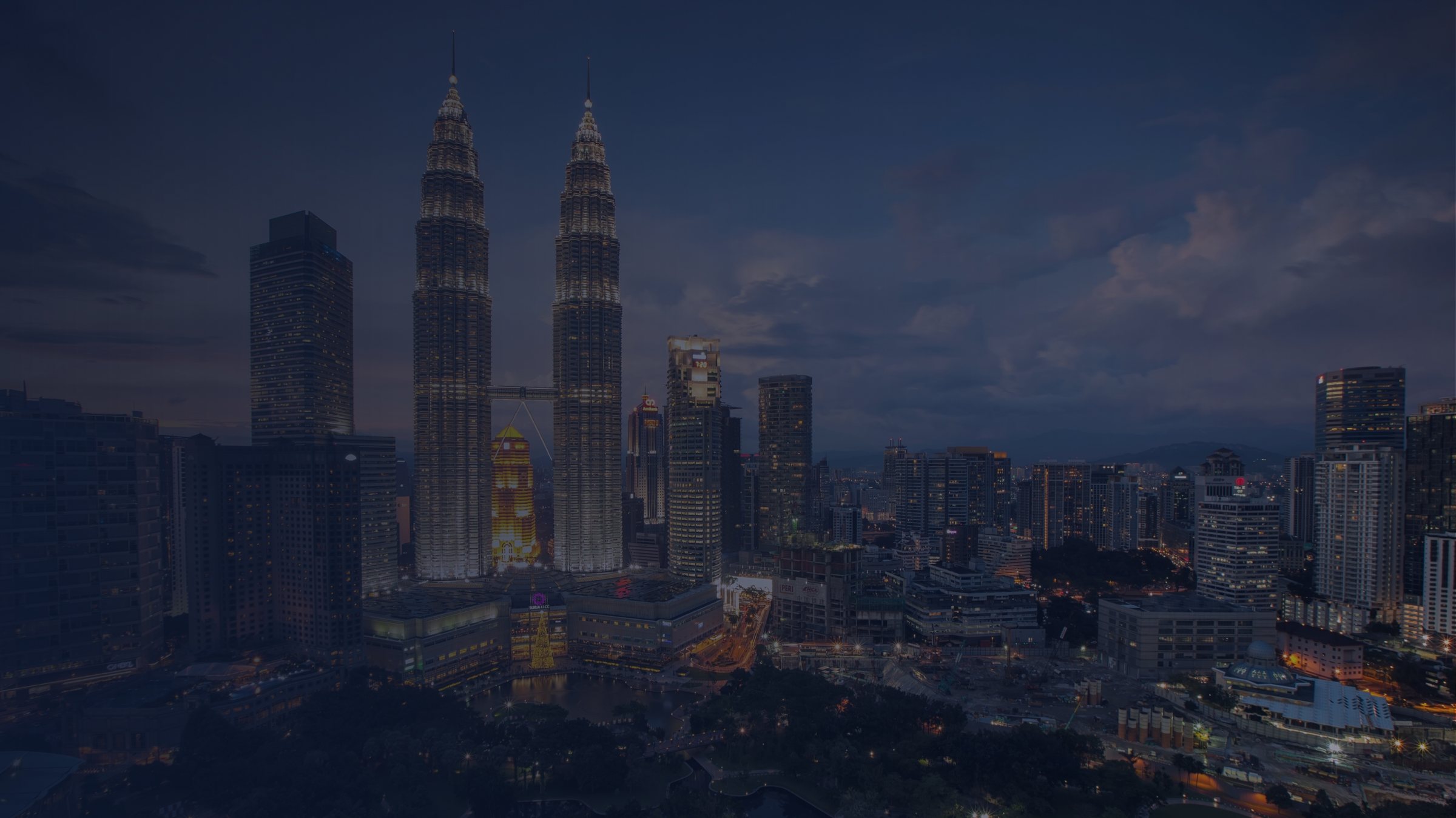 The Kuala Lumpur skyline at dusk, with the Petronas Twin Towers at its centre