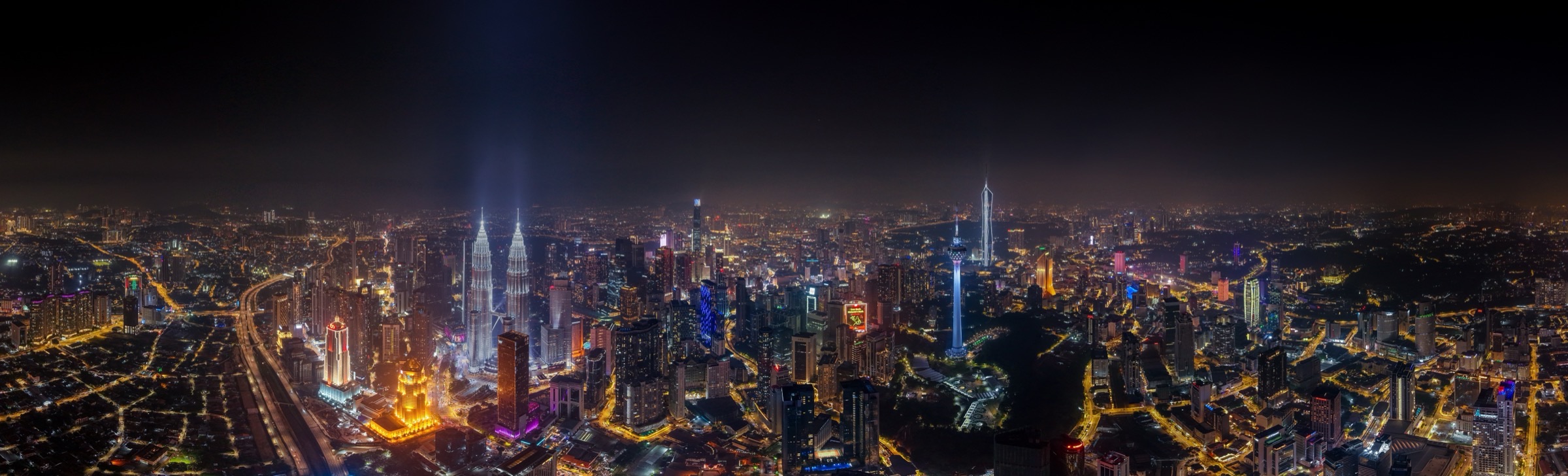 The Kuala Lumpur skyline at night, with the KL Tower, Petronas Twin Towers and Merdeka 118 lit up